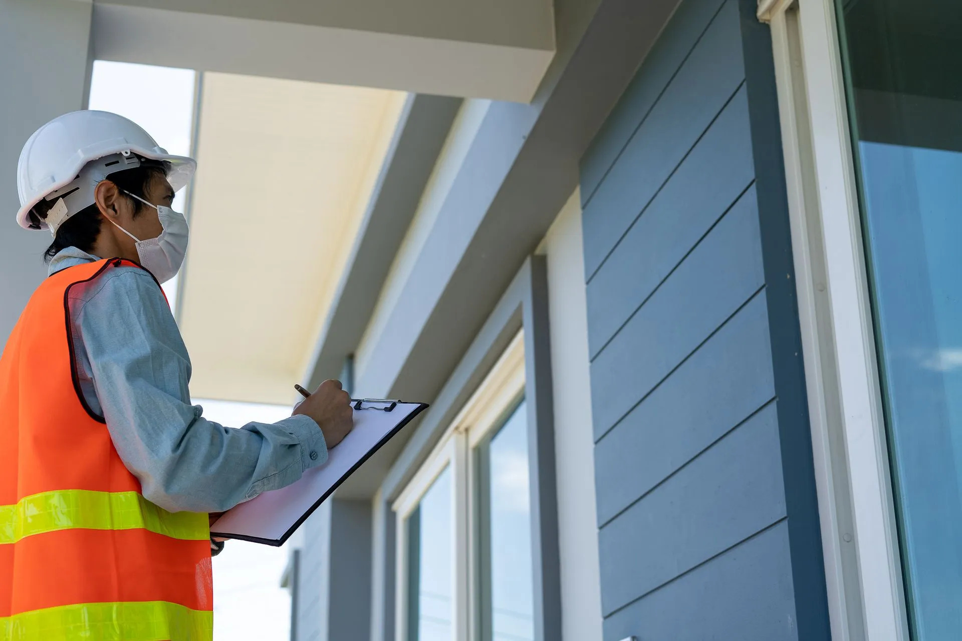 Property inspector recording condition notes on a clipboard